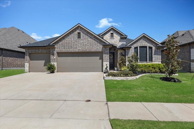 817 Layla Dr, Fate, TX 75087 - french country inspired facade featuring brick siding, an attached garage, a front yard, and driveway