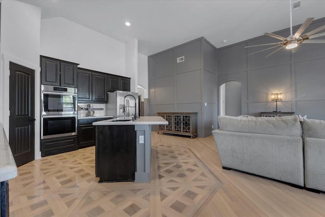 817 Layla Dr, Fate, TX 75087 - kitchen with high vaulted ceiling, appliances with stainless steel finishes, open floor plan, light countertops, and a ceiling fan