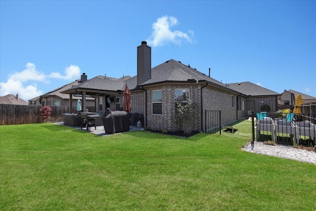 817 Layla Dr, Fate, TX 75087 - back of property featuring a patio area, brick siding, a shingled roof, a chimney, and outdoor lounge area