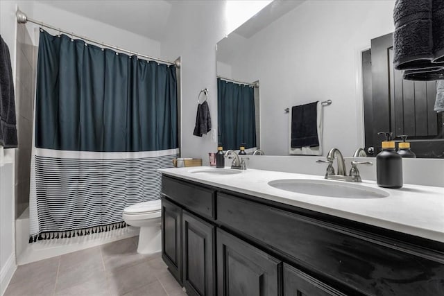 817 Layla Dr, Fate, TX 75087 - bathroom featuring double vanity, toilet, shower / bath combo with shower curtain, and tile patterned flooring