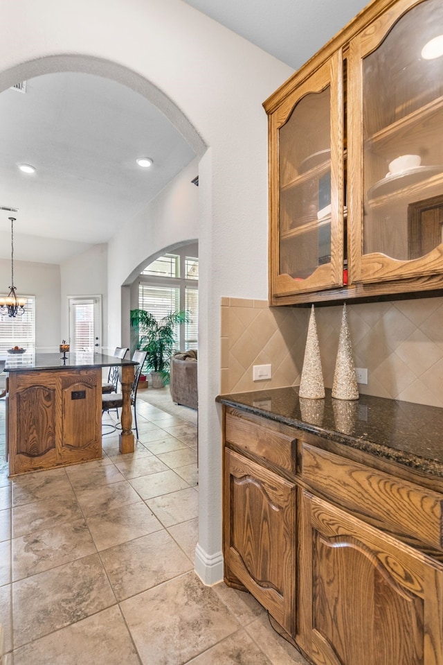 6417 Belhaven Dr, Fort Worth, TX 76123 - bar featuring decorative light fixtures, backsplash, arched walkways, and recessed lighting