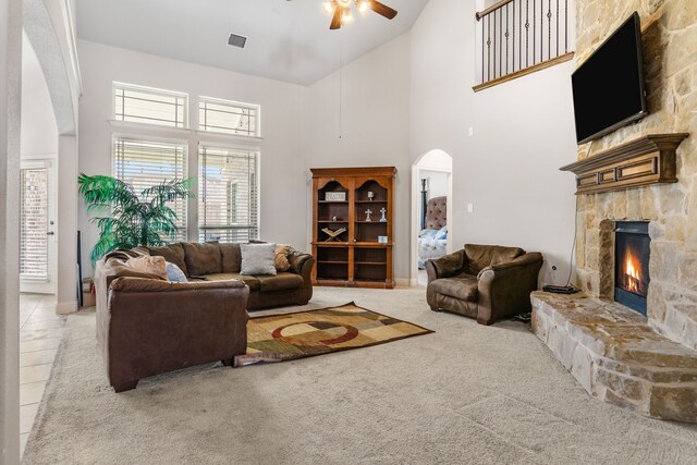 6417 Belhaven Dr, Fort Worth, TX 76123 - carpeted living room featuring high vaulted ceiling, a fireplace, visible vents, arched walkways, and ceiling fan