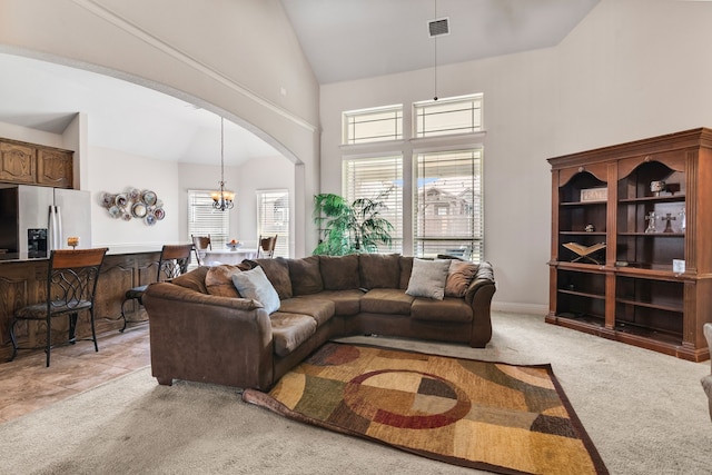 6417 Belhaven Dr, Fort Worth, TX 76123 - living area with light carpet, arched walkways, high vaulted ceiling, and visible vents