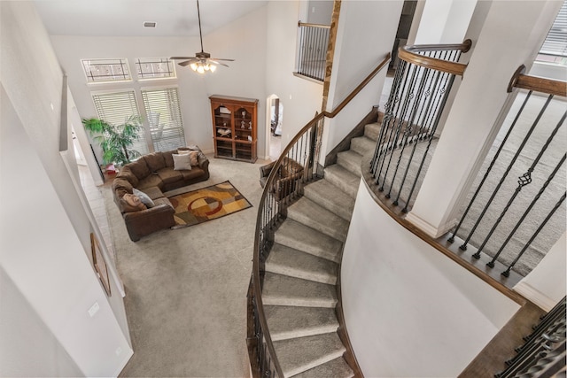 6417 Belhaven Dr, Fort Worth, TX 76123 - stairs featuring carpet, visible vents, a ceiling fan, and a high ceiling