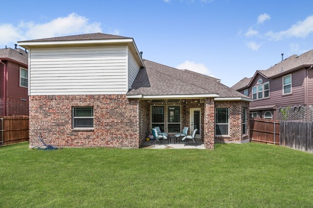 6417 Belhaven Dr, Fort Worth, TX 76123 - back of house featuring a lawn, a patio area, brick siding, and a fenced backyard