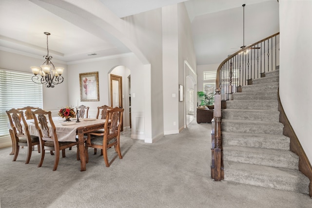 6417 Belhaven Dr, Fort Worth, TX 76123 - dining room featuring an inviting chandelier, stairs, crown molding, arched walkways, and light carpet