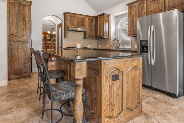 6417 Belhaven Dr, Fort Worth, TX 76123 - kitchen with stainless steel appliances, tasteful backsplash, vaulted ceiling, arched walkways, and a kitchen island