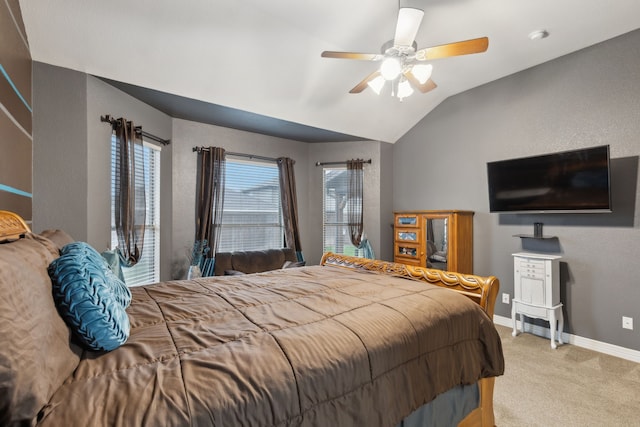 bedroom featuring a ceiling fan, lofted ceiling, baseboards, and light colored carpet