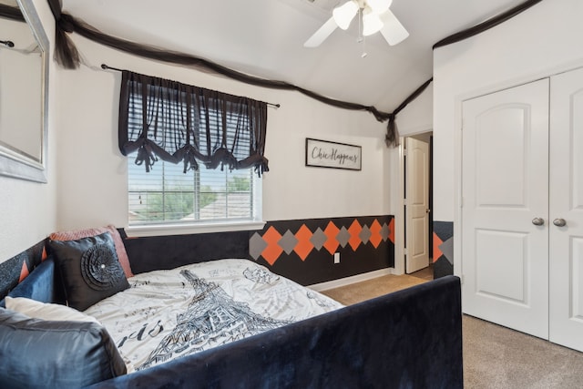 bedroom featuring carpet, a closet, and vaulted ceiling