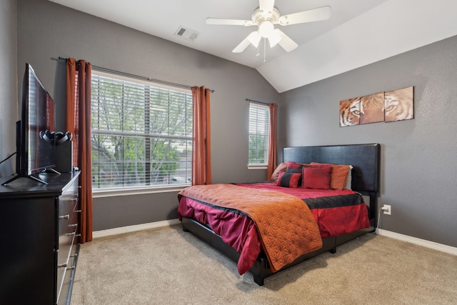 carpeted bedroom with a ceiling fan, baseboards, vaulted ceiling, and visible vents
