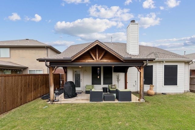 rear view of house with a chimney, a patio, a fenced backyard, outdoor lounge area, and a lawn