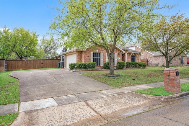 461 Sausalito Dr, Rockwall, TX 75087 - view of front of home with a garage, fence, a front lawn, brick siding, and concrete driveway