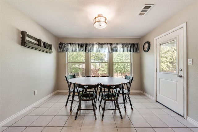 207 Shady Oaks Dr, Runaway Bay, TX 76426 - dining area with light tile patterned floors, visible vents, and baseboards