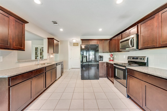 207 Shady Oaks Dr, Runaway Bay, TX 76426 - kitchen featuring visible vents, appliances with stainless steel finishes, light tile patterned flooring, a sink, and backsplash