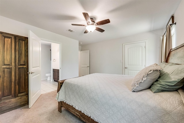 207 Shady Oaks Dr, Runaway Bay, TX 76426 - bedroom with visible vents, a ceiling fan, connected bathroom, and light tile patterned floors