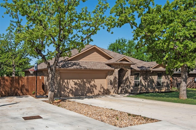 207 Shady Oaks Dr, Runaway Bay, TX 76426 - single story home featuring driveway, an attached garage, a front yard, fence, and a shingled roof