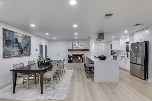 10606 Estate Ln, Dallas, TX 75238 - dining area with light wood-type flooring, recessed lighting, and a fireplace