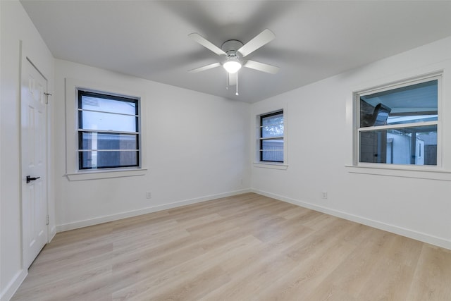 10606 Estate Ln, Dallas, TX 75238 - unfurnished room featuring light wood-style floors, plenty of natural light, a ceiling fan, and baseboards