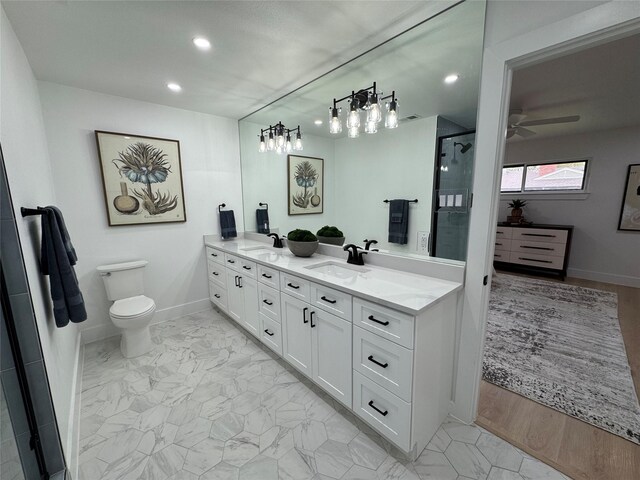 10606 Estate Ln, Dallas, TX 75238 - bathroom with a ceiling fan, a stall shower, double vanity, toilet, and recessed lighting