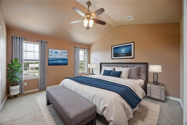 bedroom with light colored carpet, baseboards, visible vents, and lofted ceiling