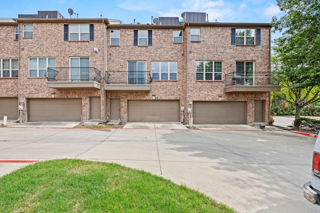 3931 Asbury Ln, Addison, TX 75001 - view of front of house with a garage, brick siding, and driveway