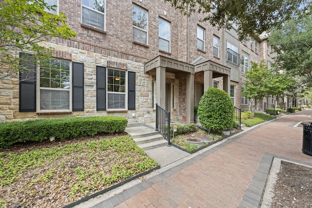 entrance to property with a residential view and stone siding