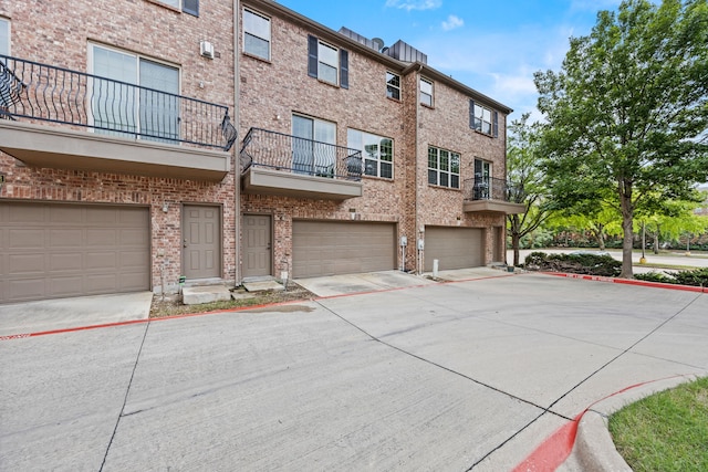 view of property featuring an attached garage and driveway