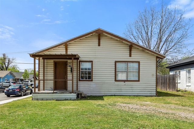 bungalow-style house featuring fence and a front lawn