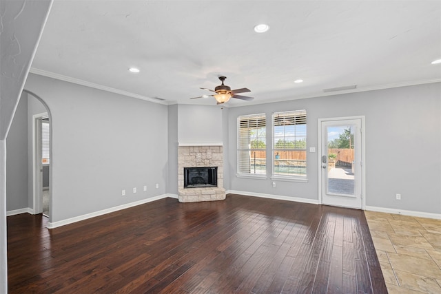 729 Ridgeway Blvd, Weatherford, TX 76086 - unfurnished living room with a ceiling fan, crown molding, a stone fireplace, recessed lighting, and baseboards