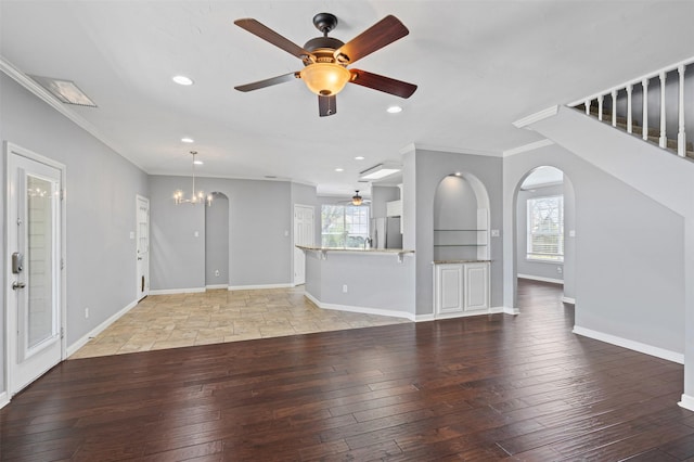 729 Ridgeway Blvd, Weatherford, TX 76086 - unfurnished living room with ceiling fan, arched walkways, plenty of natural light, crown molding, and a chandelier