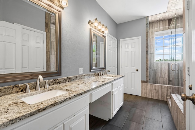 729 Ridgeway Blvd, Weatherford, TX 76086 - bathroom with tiled shower, double vanity, and tiled bath