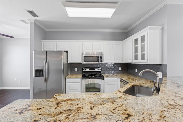 729 Ridgeway Blvd, Weatherford, TX 76086 - kitchen with stainless steel appliances, a sink, light stone countertops, dark wood-style flooring, and white cabinets