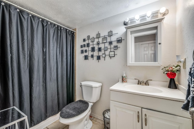 5212 Knox Dr, The Colony, TX 75056 - full bathroom with a textured ceiling, vanity, a shower with curtain, tile patterned flooring, and toilet