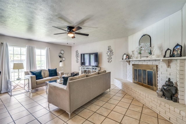 5212 Knox Dr, The Colony, TX 75056 - living area with light tile patterned floors, a textured ceiling, a ceiling fan, and a fireplace