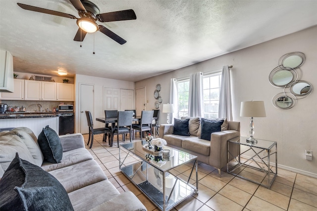 5212 Knox Dr, The Colony, TX 75056 - living room featuring light tile patterned floors, baseboards, a textured ceiling, and ceiling fan