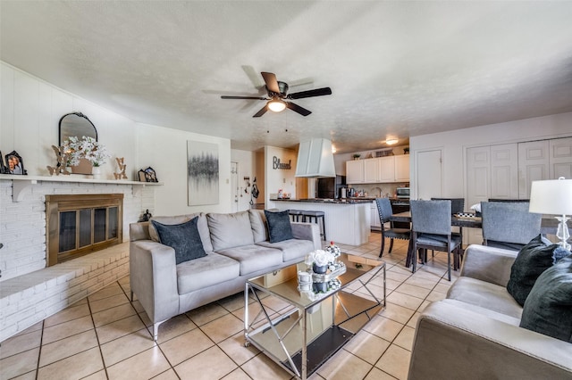 5212 Knox Dr, The Colony, TX 75056 - living room with light tile patterned floors, ceiling fan, and a brick fireplace