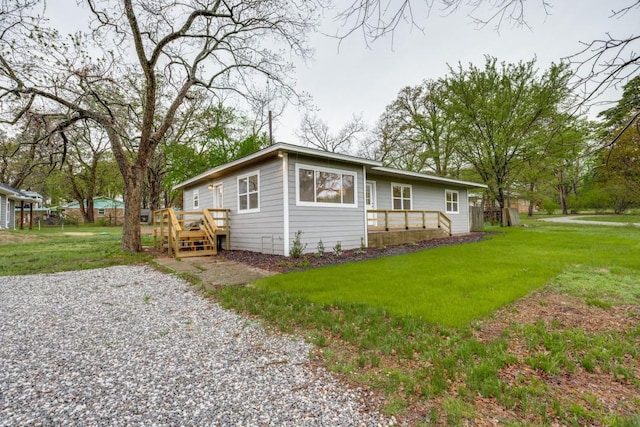view of front of house with a front lawn, fence, and a deck