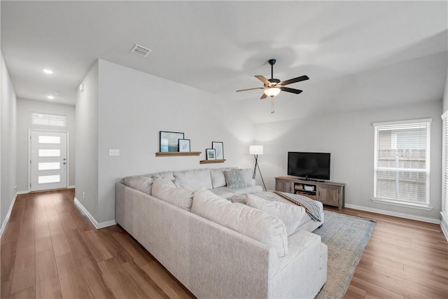 11220 Pallasite Ct, Waco, TX 76655 - living area with healthy amount of natural light, a ceiling fan, wood finished floors, baseboards, and vaulted ceiling