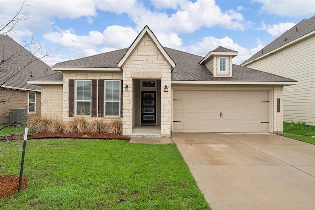 11220 Pallasite Ct, Waco, TX 76655 - view of front facade with roof with shingles, a front lawn, concrete driveway, a garage, and stone siding