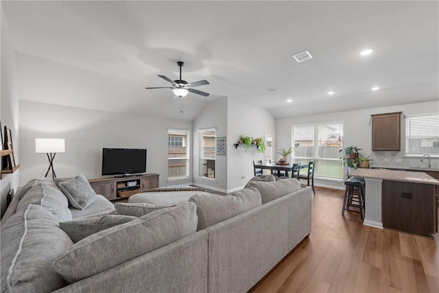 11220 Pallasite Ct, Waco, TX 76655 - living room featuring wood finished floors, vaulted ceiling, a ceiling fan, recessed lighting, and baseboards