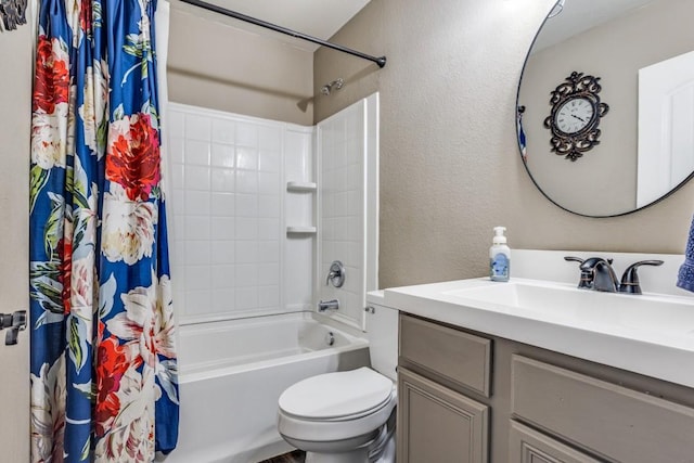 bathroom with toilet, shower / tub combo with curtain, a textured wall, and vanity