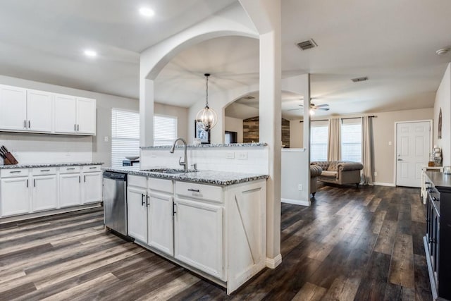 kitchen with ceiling fan, dishwasher, a sink, visible vents, and dark wood-type flooring