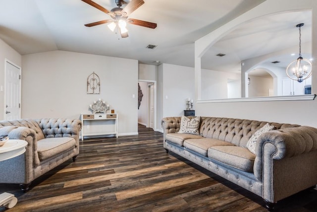 living area featuring visible vents, wood finished floors, ceiling fan with notable chandelier, and vaulted ceiling