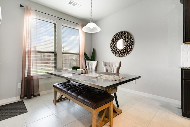 dining room featuring visible vents, baseboards, and plenty of natural light