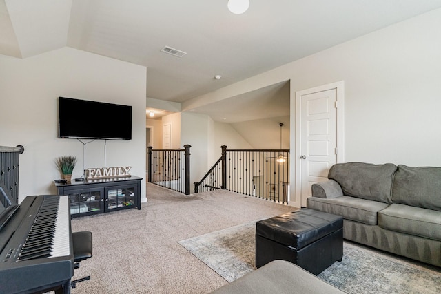 living room with carpet floors, vaulted ceiling, and visible vents