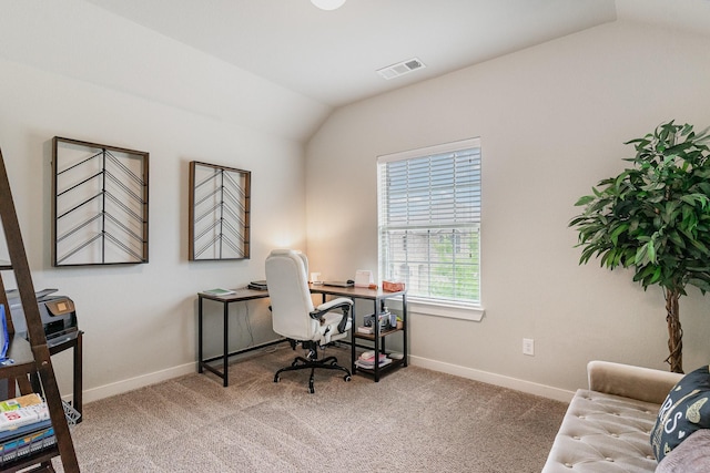 carpeted office featuring baseboards, lofted ceiling, and visible vents