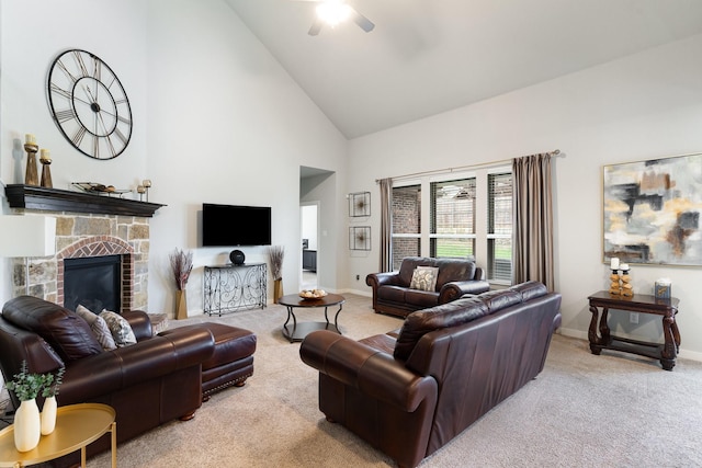 carpeted living area with a stone fireplace, a ceiling fan, baseboards, and high vaulted ceiling