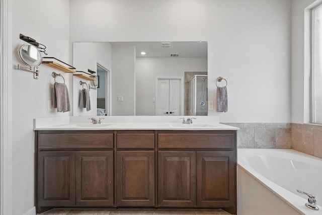 9100 Pearfield Rd, Fort Worth, TX 76179 - full bathroom with double vanity, a sink, a garden tub, and a shower stall