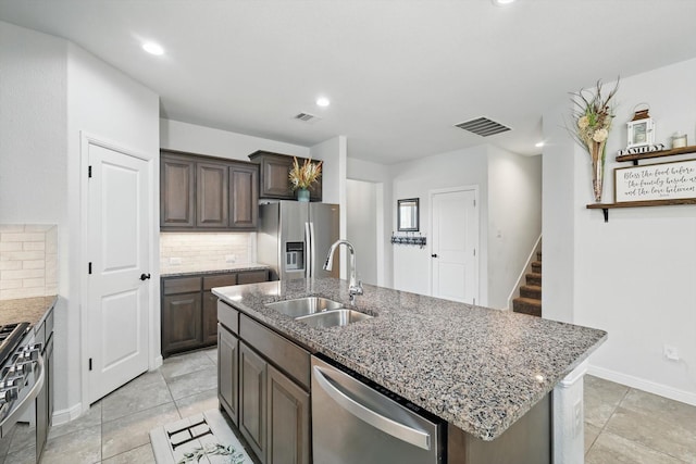 9100 Pearfield Rd, Fort Worth, TX 76179 - kitchen featuring dark brown cabinets, visible vents, a sink, and stainless steel appliances
