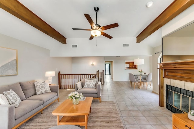 5915 Volunteer Pl, Rockwall, TX 75032 - living area featuring beamed ceiling, a ceiling fan, light tile patterned floors, a tiled fireplace, and baseboards